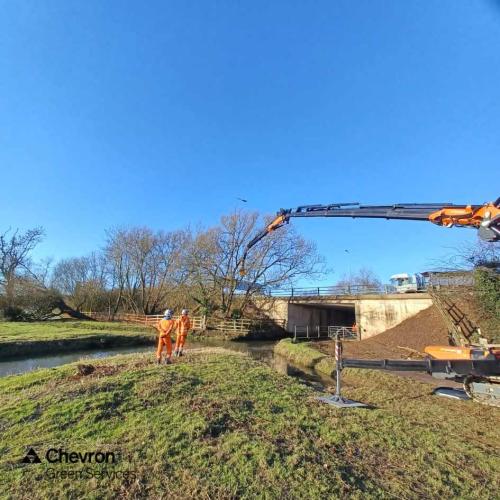 Mech arb used for limited access tree removal beside large body of water
